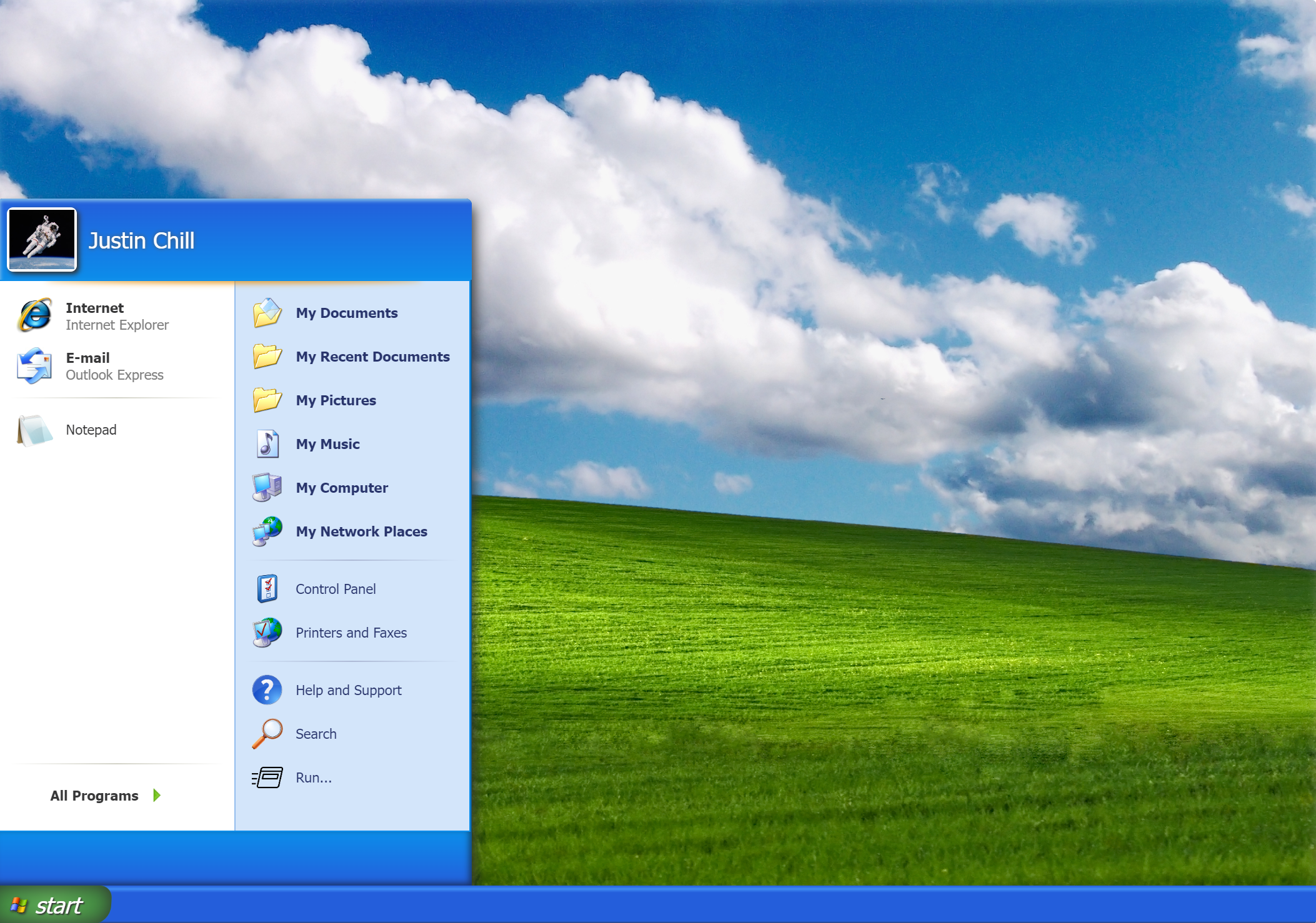 A computer desktop screen displaying a Windows XP interface with the Start menu open. The menu lists programs like Internet Explorer and Outlook Express. The background features a green hill and a blue sky with scattered clouds.